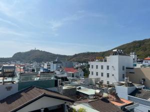 a city with buildings and a mountain in the background at Residence Á CHÂU in Vung Tau
