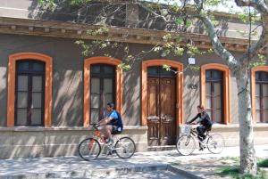 two people riding bikes in front of a building at Dpto 3P - Barrio Italia - Santiago de Chile in Santiago