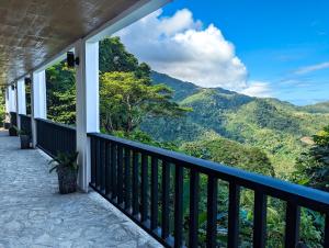 a balcony with a view of the mountains at Ponderosa Golf and Country Club in Puerto Galera