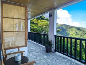 a balcony with a view of the mountains at Ponderosa Golf and Country Club in Puerto Galera