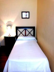 Posteľ alebo postele v izbe v ubytovaní Hotel Simon