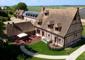 an aerial view of a large house with a yard at Manoir de Surville Hotel & Spa & restaurant in Surville