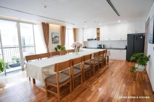 a kitchen with a long table and chairs in a room at Modern & Charming Penthouse 5BRs in Da Nang Center in Da Nang