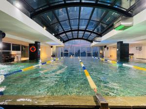 a large indoor swimming pool with a glass ceiling at Modern & Charming Penthouse 5BRs in Da Nang Center in Da Nang