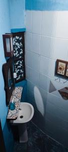 a blue bathroom with a sink and a toilet at Nirvana Ecolodge - Private accomodations in the beach side of Atlantic forest in Florianópolis