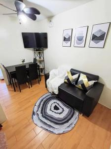 a living room with a couch and a table at Davao Condo 2BR Pool Wifi Netflix in Davao City