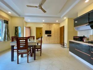 a kitchen and dining room with a table and chairs at Hotel Kedar inn in Rishīkesh