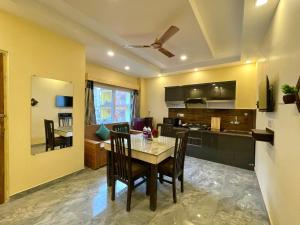 a kitchen and dining room with a table and chairs at Hotel Kedar inn in Rishīkesh