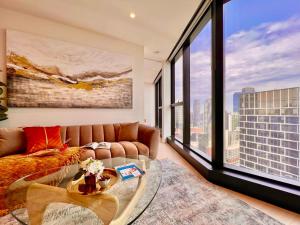 een woonkamer met een bank en een glazen tafel bij High rise top view 2bed2bath in Melbourne