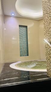 a bathroom with a large tub with a window at Walking distance to dubai mall Full burj Khalifa view and fountain view new year full fireworks view 2BR in Dubai