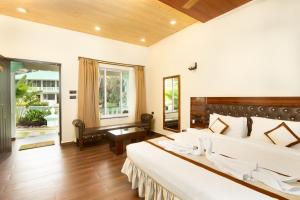 a bedroom with two beds and a large window at D7 La Serene in Benaulim