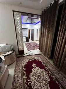 a living room with a large rug on the floor at exclusive apartment for bash in Faridabad