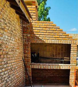 a brick fireplace with a cat sitting in it at Dichato in Punta del Este