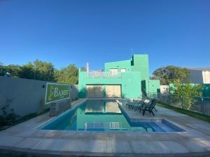 a house with a swimming pool in the backyard at Bambú Hotel in Chepes