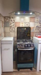 a kitchen with a stove and a counter top at Apartamento céntrico Frida's todo nuevo in Tarija