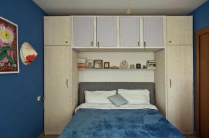 a bedroom with a bed with white cabinets at Apartment with Garden in Romano di Lombardia