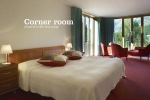 a bedroom with a bed with two pillows on it at Hotel Saratz Pontresina in Pontresina