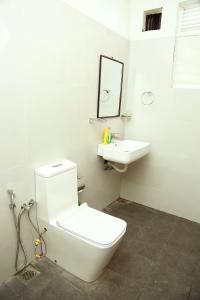 a bathroom with a white toilet and a sink at Eden Rock Luxurious Accommodation in Kandy