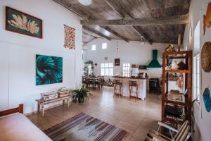 a living room with white walls and a wooden ceiling at Maruja in Ilhabela