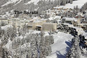 a town covered in snow with the santatal sign on it at Hotel Saratz Pontresina in Pontresina