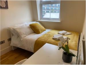 Ένα ή περισσότερα κρεβάτια σε δωμάτιο στο Cosy Private Rooms in Euston Square, Central London
