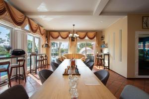 uma sala de estar com uma grande mesa de madeira e cadeiras em Hacienda Resort - Mae Phim em Mae Pim