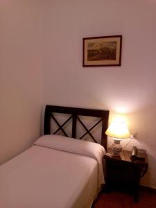 Posteľ alebo postele v izbe v ubytovaní Hotel Simon