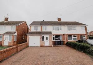 a house with a brick driveway in front of it at Relaxing Apartment - Special Offer for Long Stays! in North Hykeham