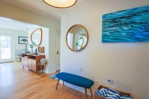 a living room with a blue chair and a mirror at Heron Hideaway in Folly Beach