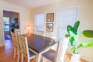 a dining room with a table and chairs and a plant at Heron Hideaway in Folly Beach