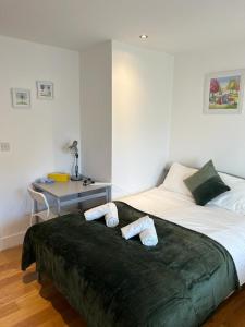 a bedroom with a bed with two pillows on it at Private Rooms near Euston Station, Central London (123) in London