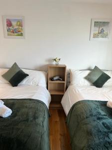 two beds sitting next to each other in a room at Private Rooms near Euston Station, Central London (123) in London