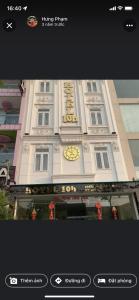 a building with a clock on the front of it at HOTEL10H in Ho Chi Minh City