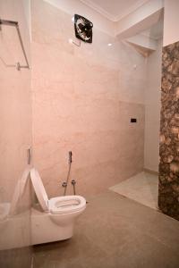 a bathroom with a toilet and a shower at Surendra Villa in Ayodhya