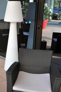 a chair and a lamp sitting next to a table at Executive Bergamo in San Paolo D'Argon
