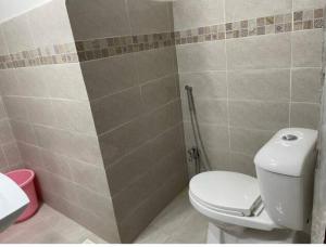 a bathroom with a toilet and a shower at Marine Tower in Rawalpindi +30 photos