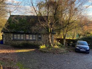 a car parked in front of a stone house at The Dovecote in Launceston