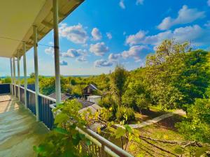 a view from the balcony of a house with trees at Home Inn Samegrelo in Kheta