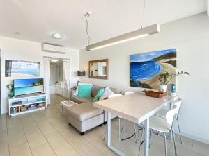 a living room with a table and a couch at 1 Bright Point Apartment 3104 in Nelly Bay