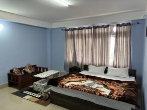 a bedroom with a large bed and a window at Hotel Vivid Tawang in Tawang