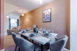 a dining room with a table and chairs at Beautiful House near Etihad with Free WiFi & Parking- Sleeps 6 by PureStay in Manchester