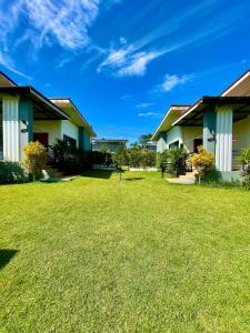 a row of houses with a green yard at KhaoLak Chill Out in Khao Lak