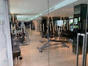 a gym with cardio equipment in a building at The Base Central Pattaya by Leya in Pattaya Central