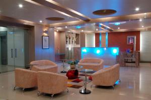 a lobby with a waiting room with chairs and a table at Treebo Trend Paradise in Ahmedabad