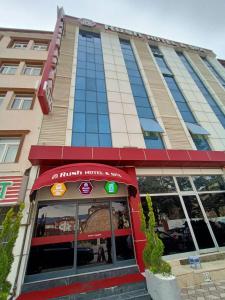 a hotel front of a building with a red awning at Rush Hotel Tokat in Tokat