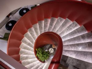 a red spiral staircase with food in the middle at Yunju Hotel Beijing Yonghe Palace Guijie Siheyuan in Beijing