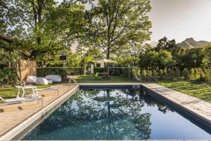 a swimming pool in a yard with a wooden deck at Villa Tina in Taormina