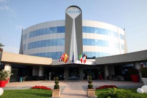 a building with flags in front of it at Executive Bergamo in San Paolo D'Argon