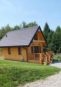 a log cabin with a porch and a deck at Domeczek Tymoneczek in Ustrzyki Dolne
