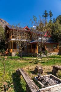 a house with a garden in front of it at Boho Grove Cafe & Stay, Tirthan Valley in Banjār